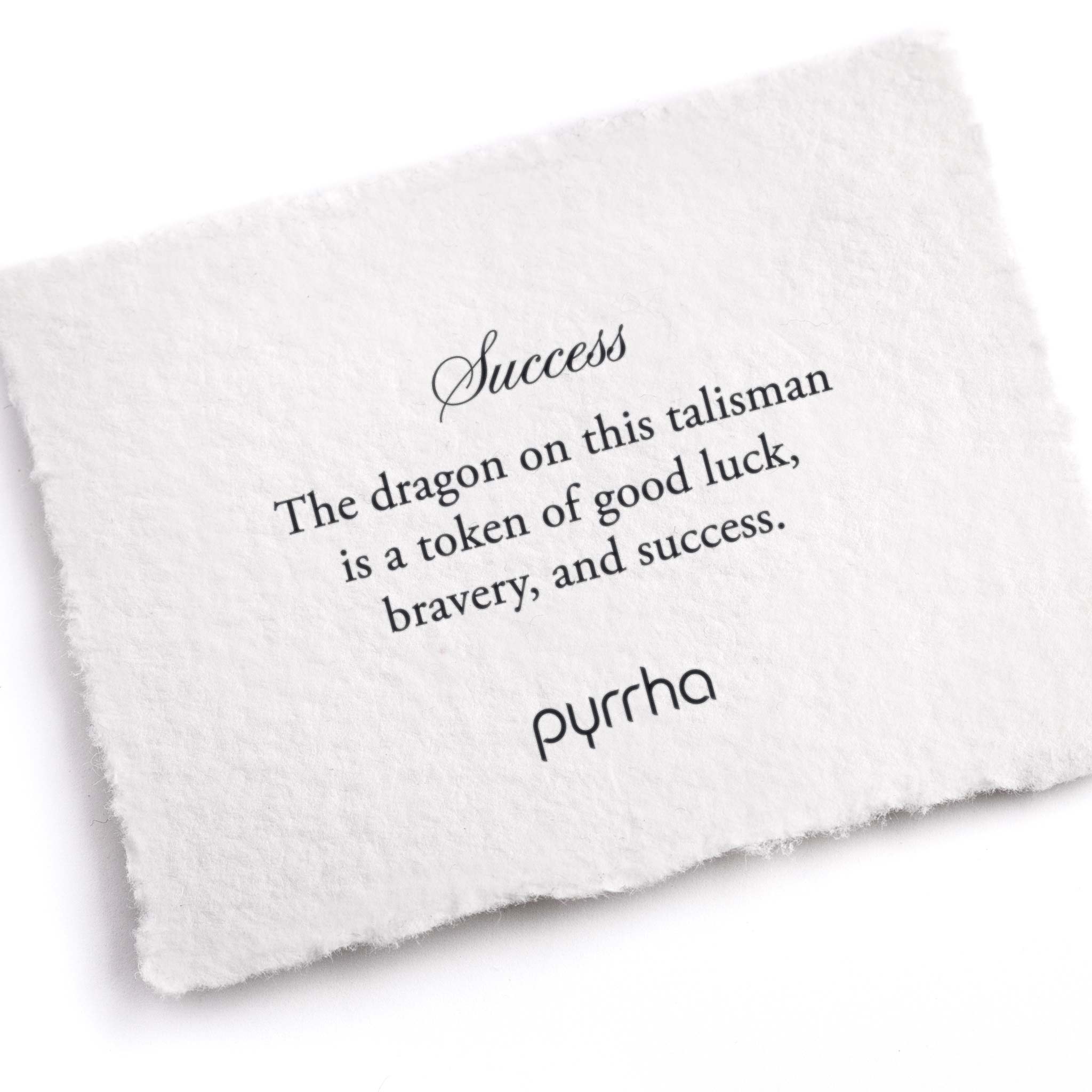 A hand-torn, letterpress printed card describing the meaning for Pyrrha's Success Talisman
