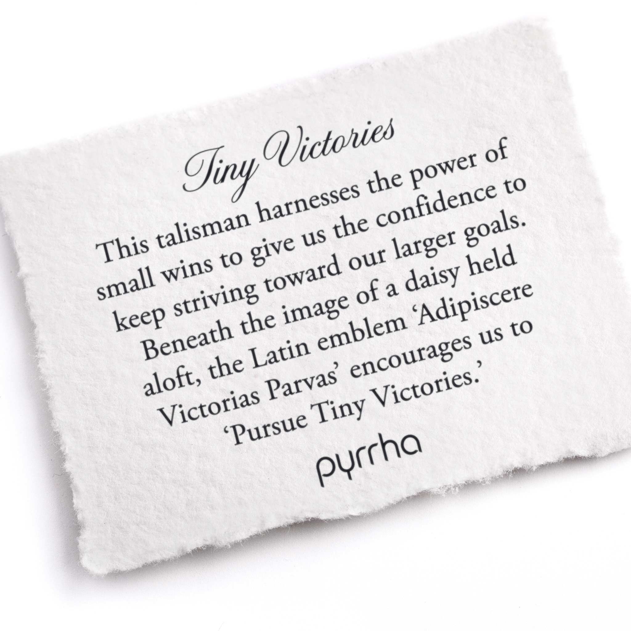 A hand-torn, letterpress printed card describing the meaning for Pyrrha's Tiny Victories Talisman