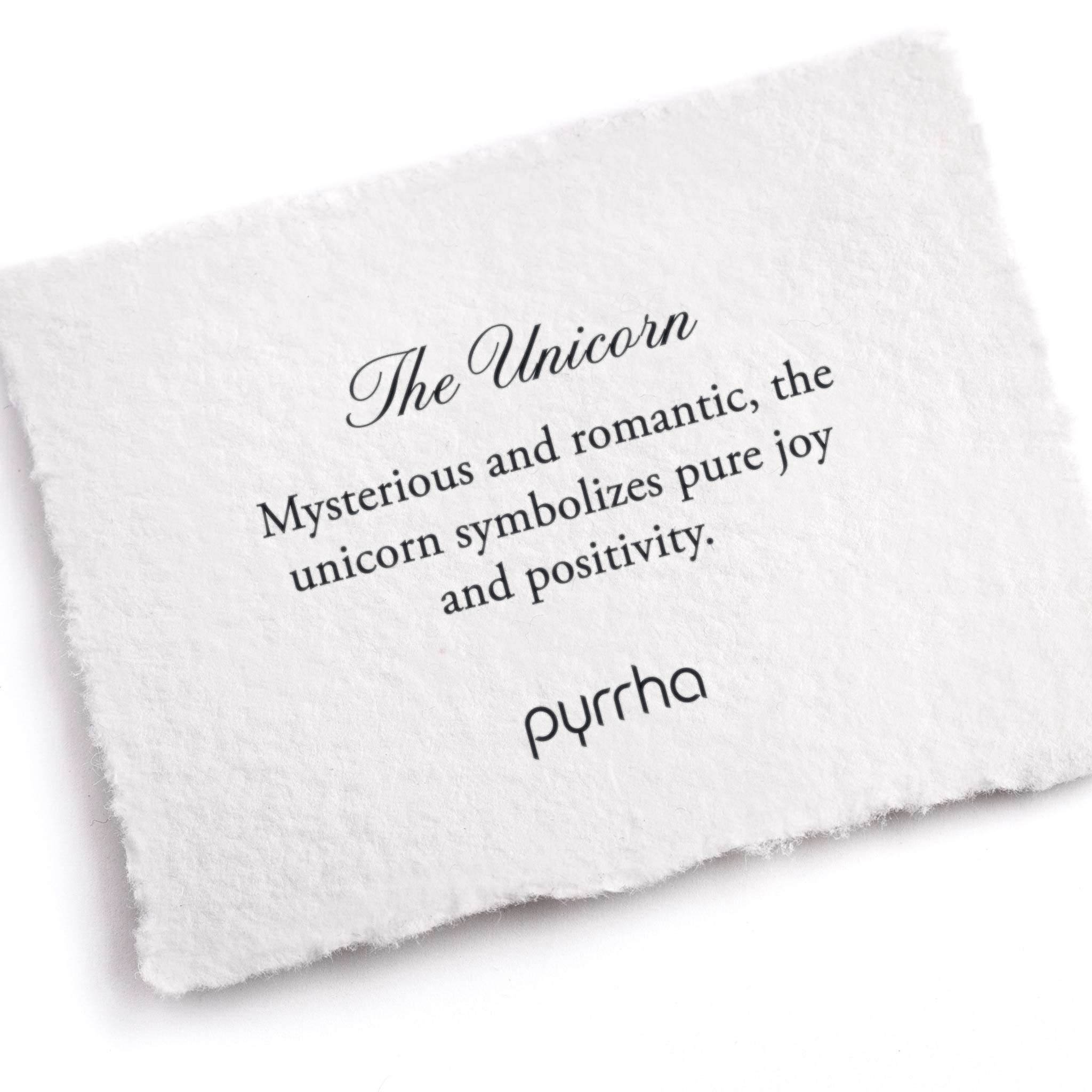 A hand-torn, letterpress printed card describing the meaning for Pyrrha's Unicorn Pin