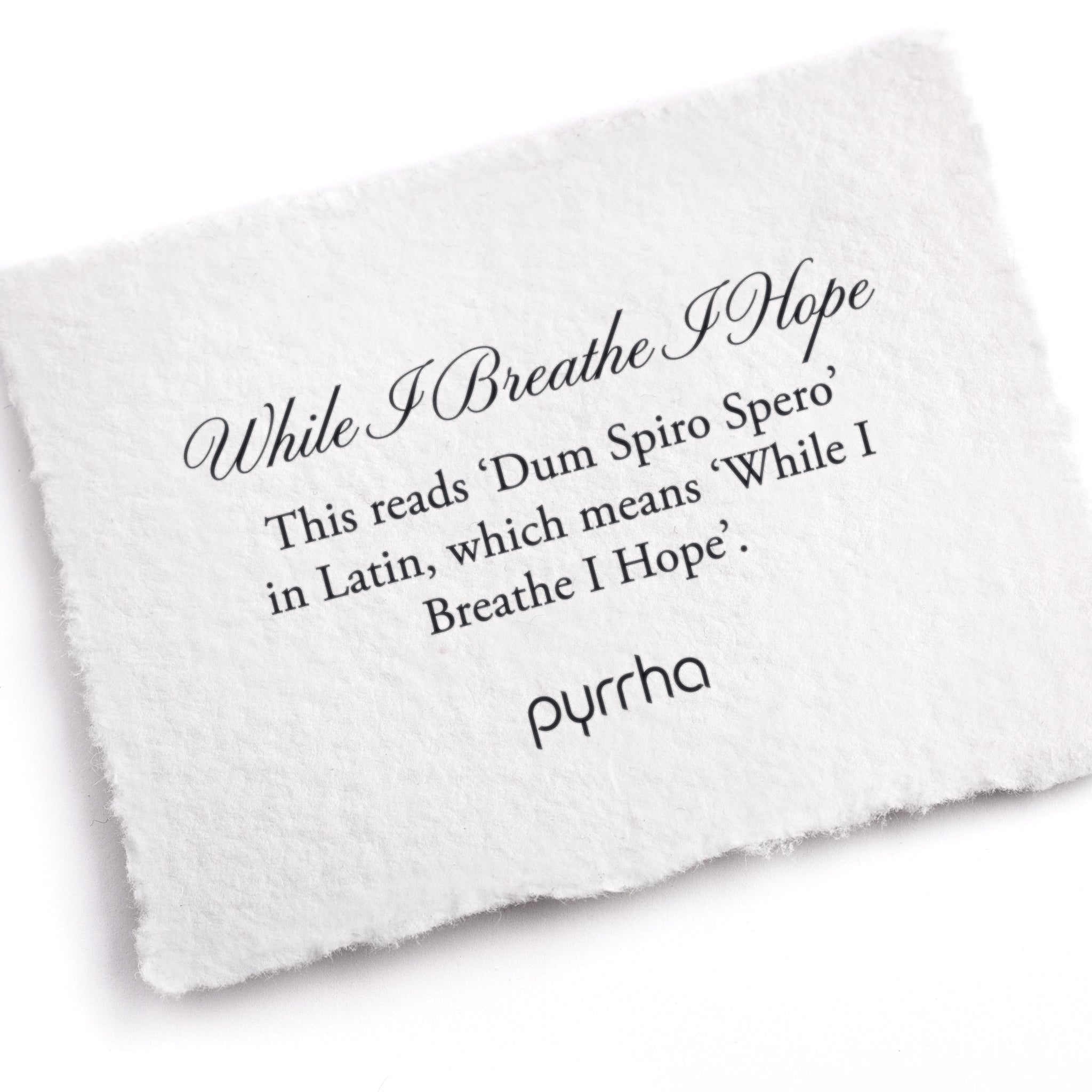 A hand-torn, letterpress printed card describing the meaning for Pyrrha's While I Breathe I Hope Ring