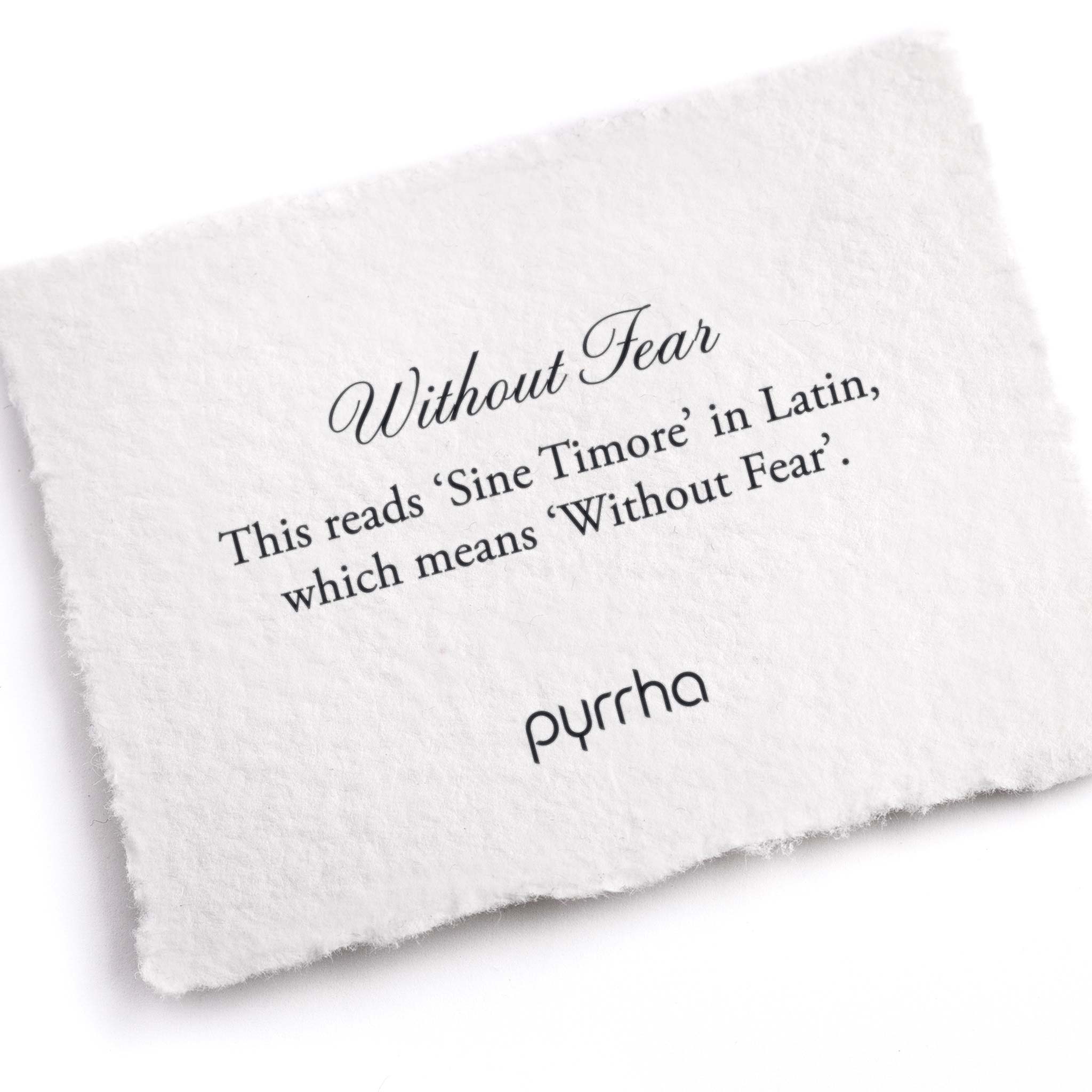 A hand-torn, letterpress printed card describing the meaning for Pyrrha's Without Fear Latin Motto Band Ring