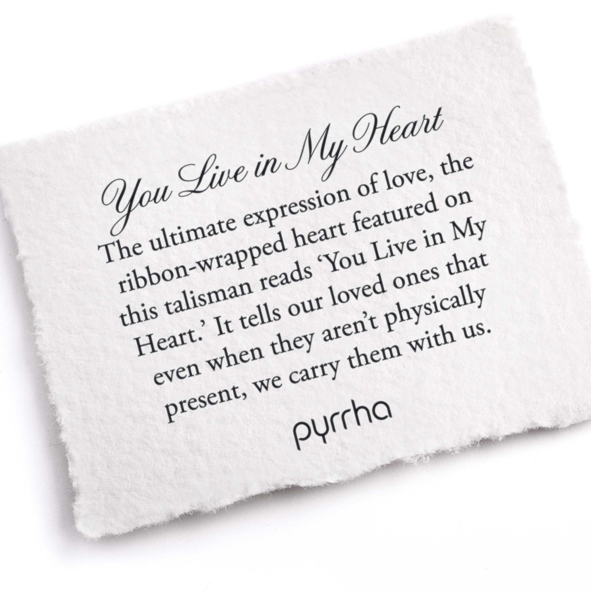A hand-torn, letterpress printed card describing the meaning for Pyrrha's You Live in My Heart Talisman