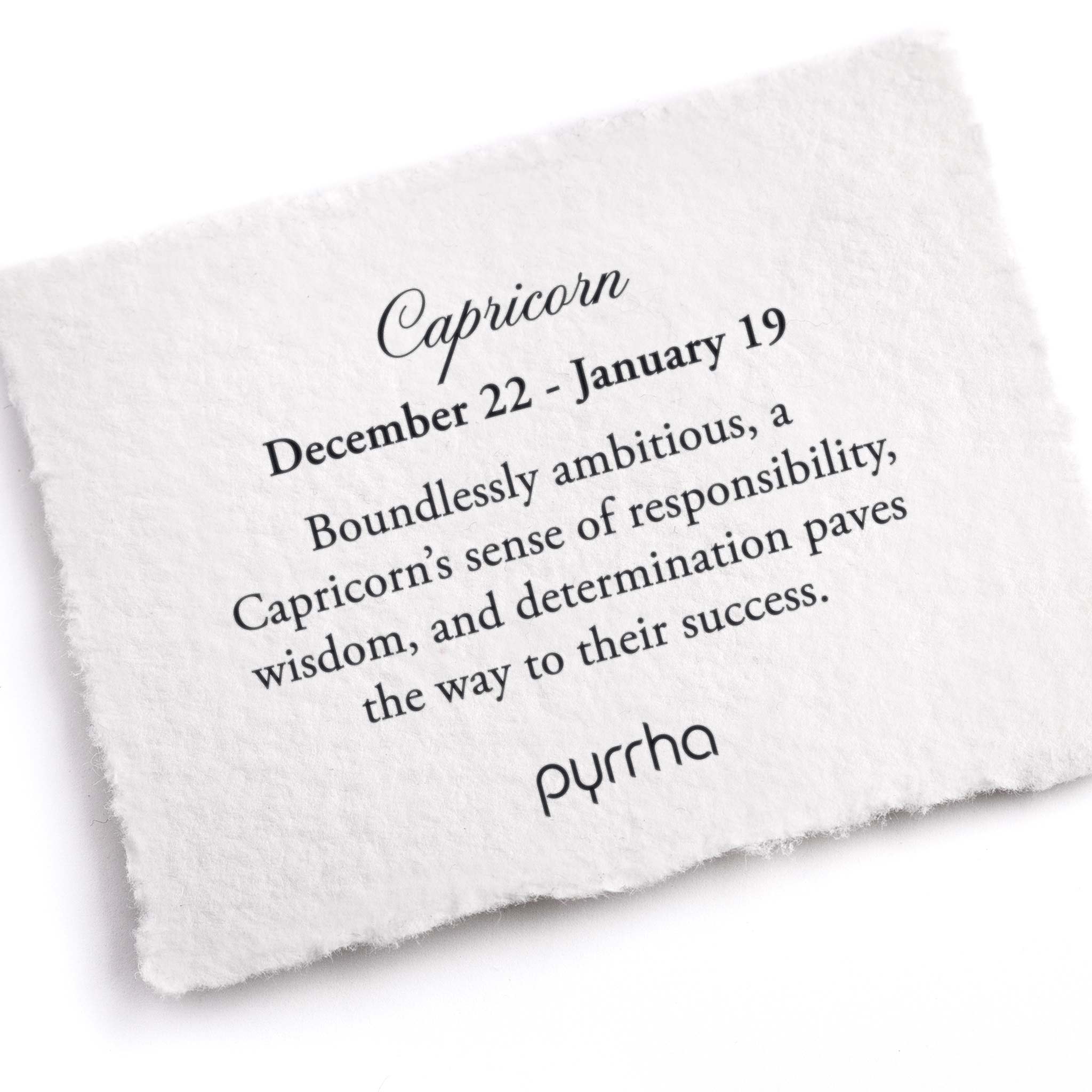 A hand-torn, letterpress printed card describing the meaning for Pyrrha's Capricorn Zodiac Talisman