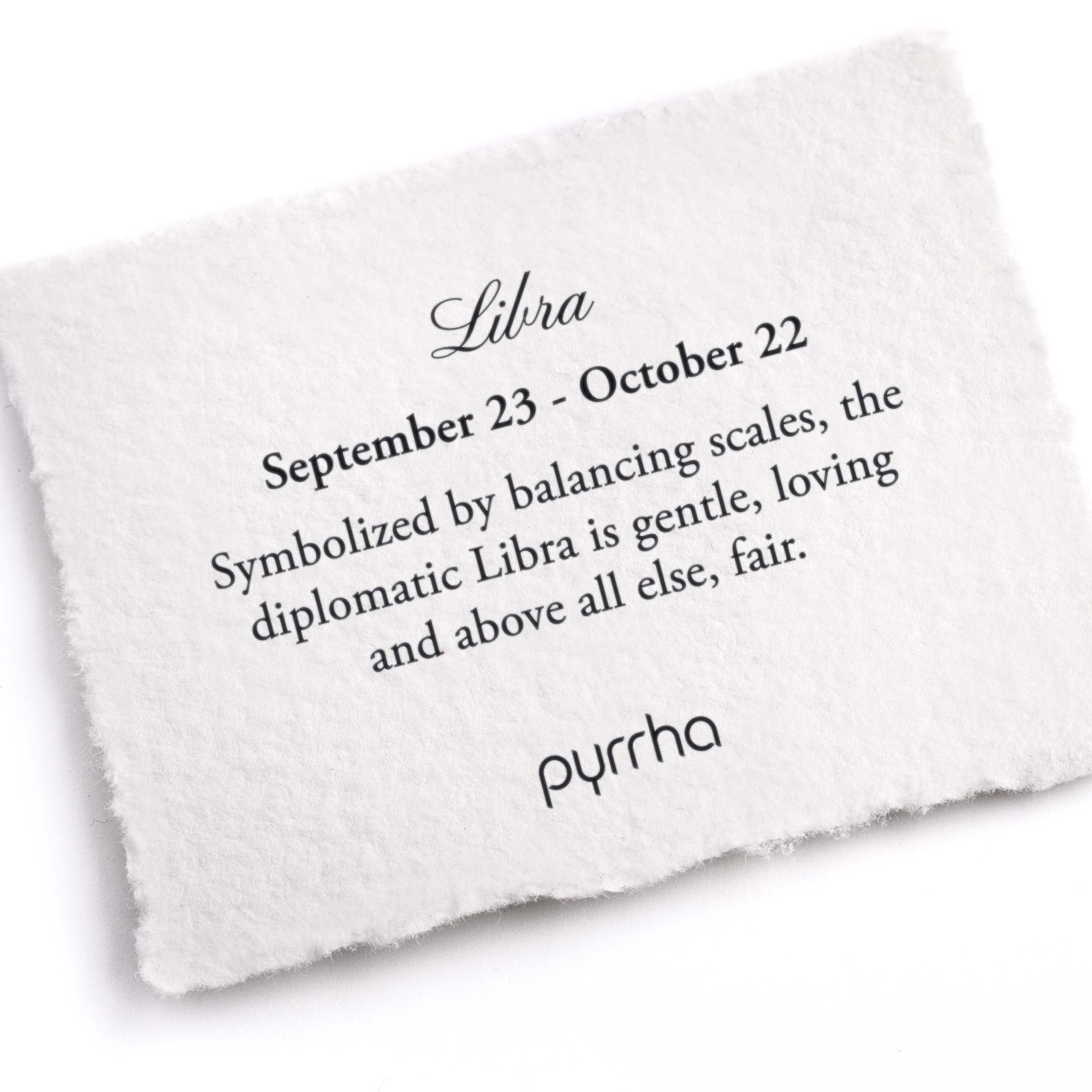 A hand-torn, letterpress printed card describing the meaning for Pyrrha's Libra Zodiac Talisman