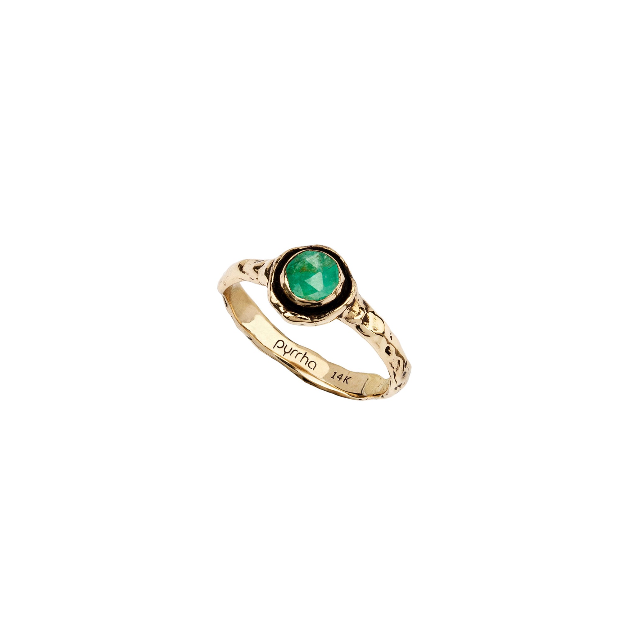 A narrow 14k gold ring set with an emerald.
