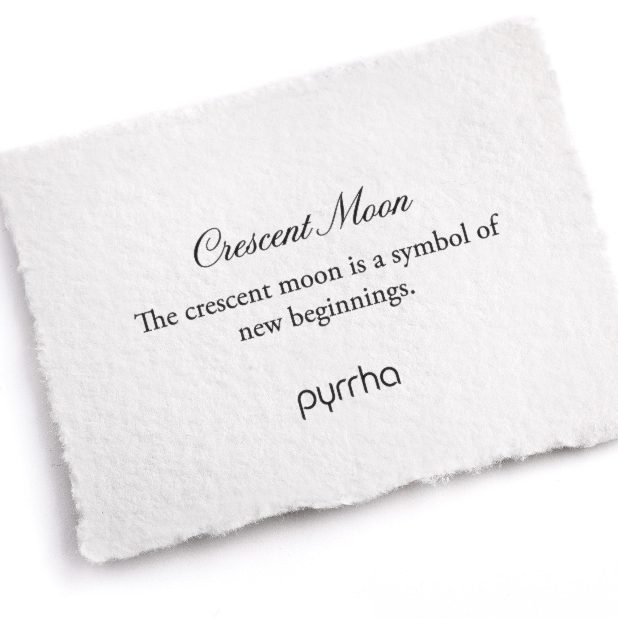 A hand-torn, letterpress printed card describing the meaning for Pyrrha's Crescent Moon Symbol Charm