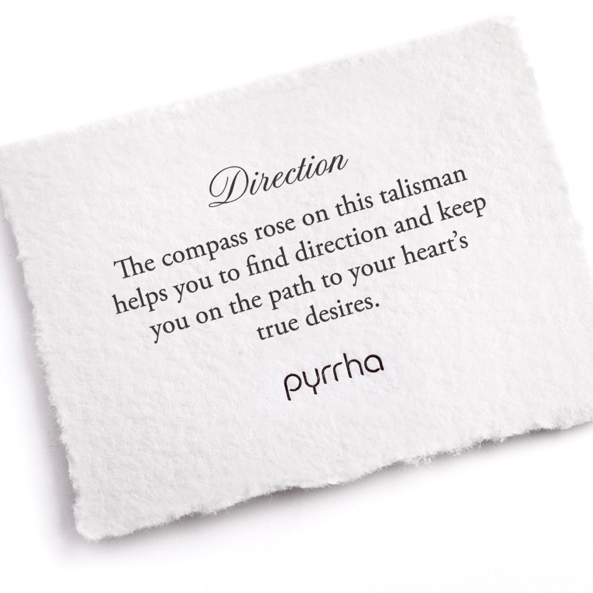 A hand-torn, letterpress printed card describing the meaning for Pyrrha's Direction Talisman