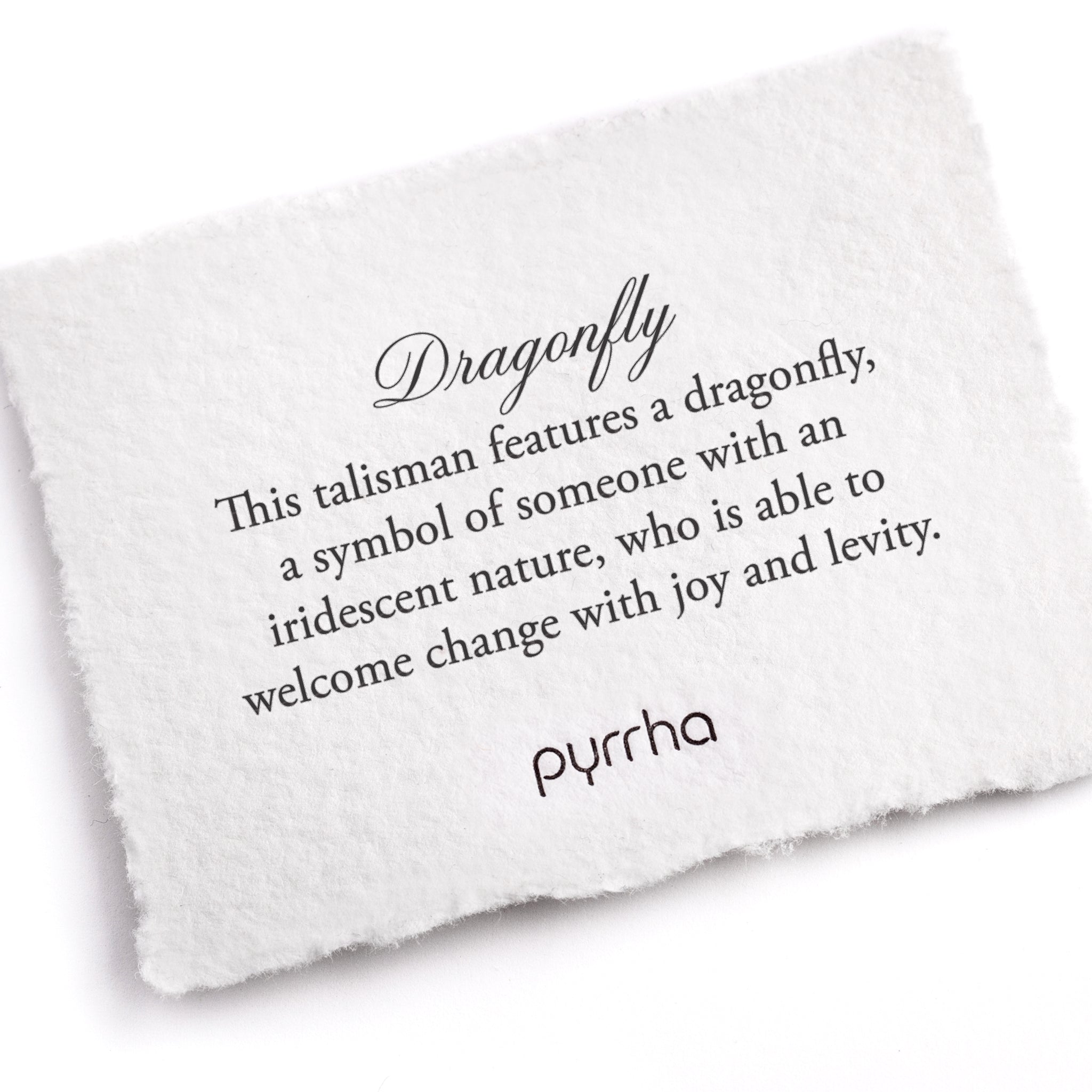 A hand-torn, letterpress printed card describing the meaning for Pyrrha's Dragonfly Talisman