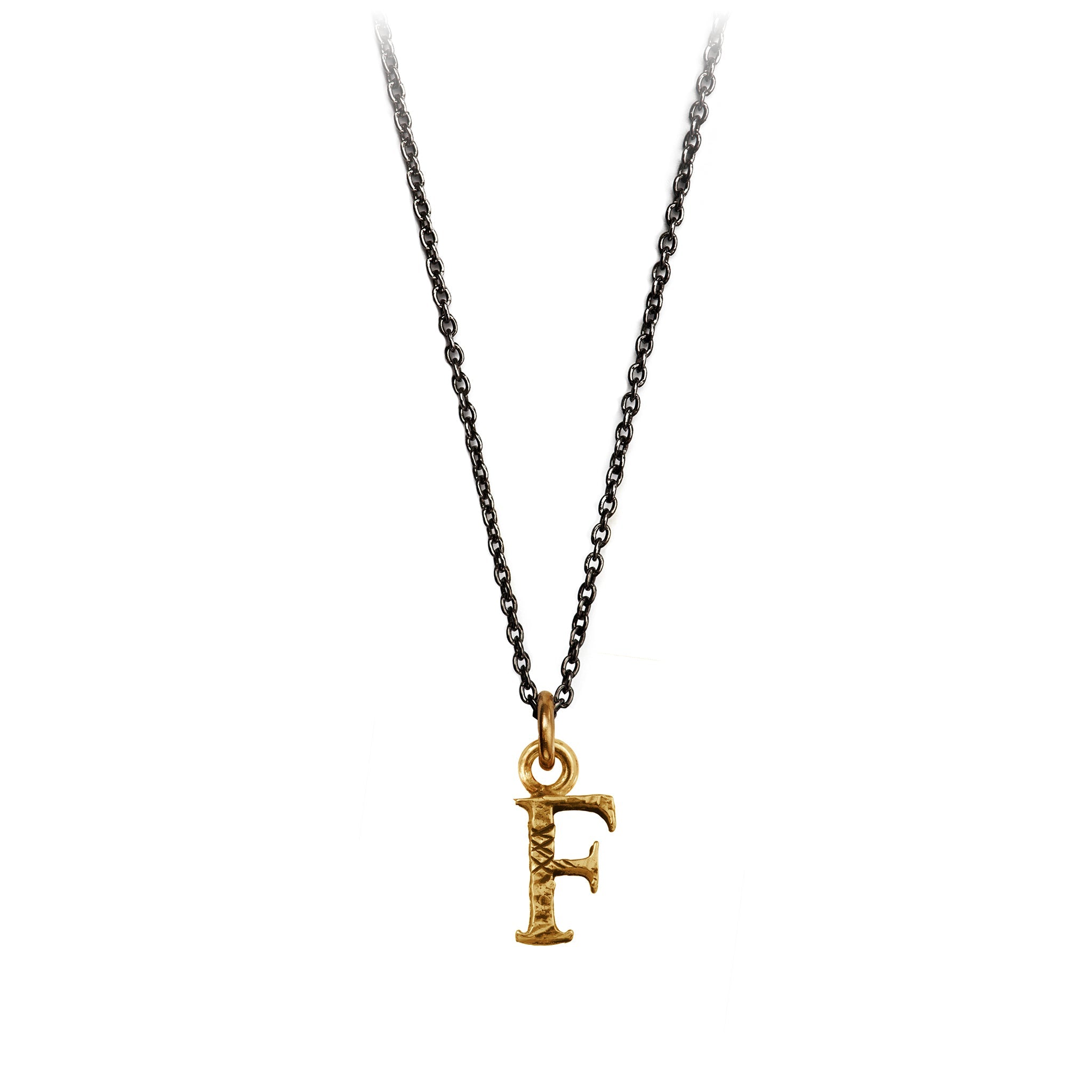 A bronze "F" charm on a blackened sterling silver chain.