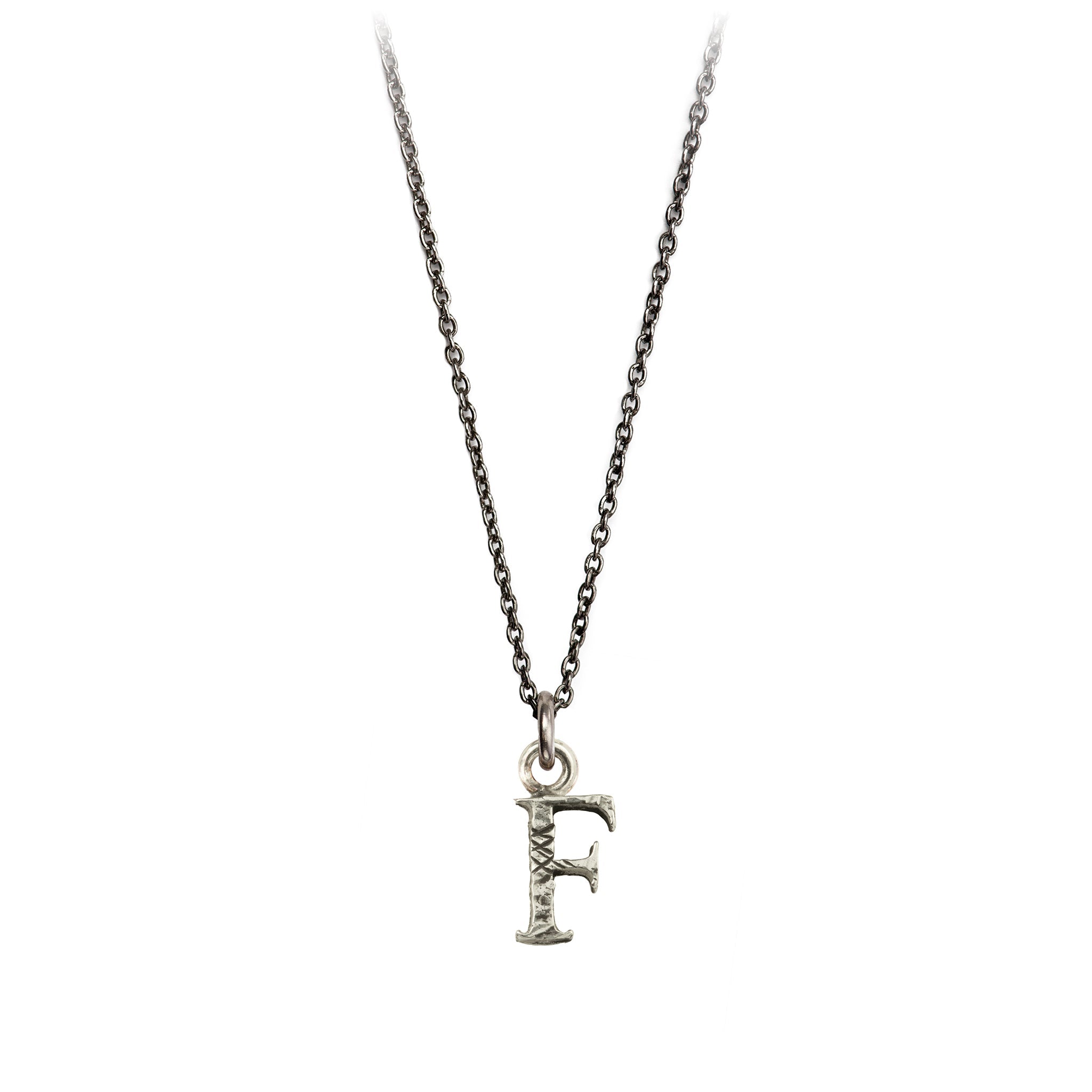 A sterling silver letter "F" charm on a silver chain.