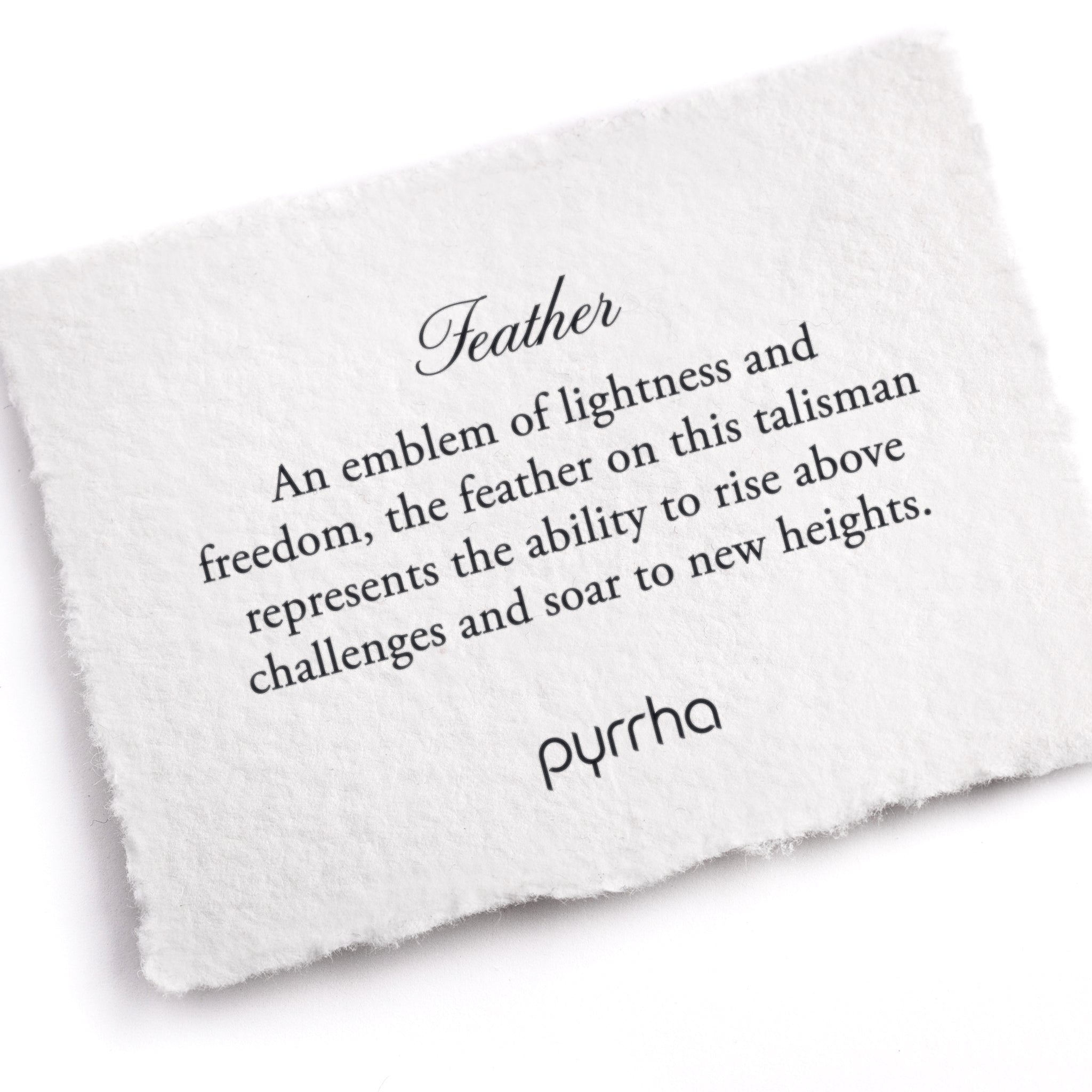 A hand-torn, letterpress printed card describing the meaning for Pyrrha's Feather Talisman