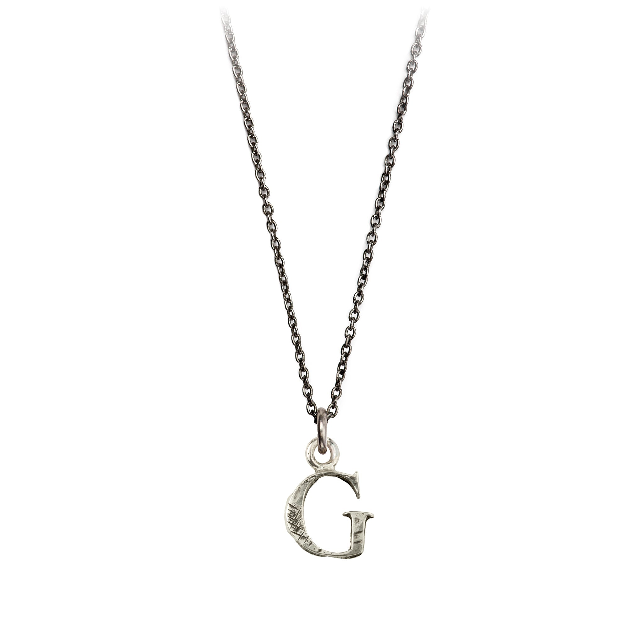 A sterling silver letter "G" charm on a silver chain.