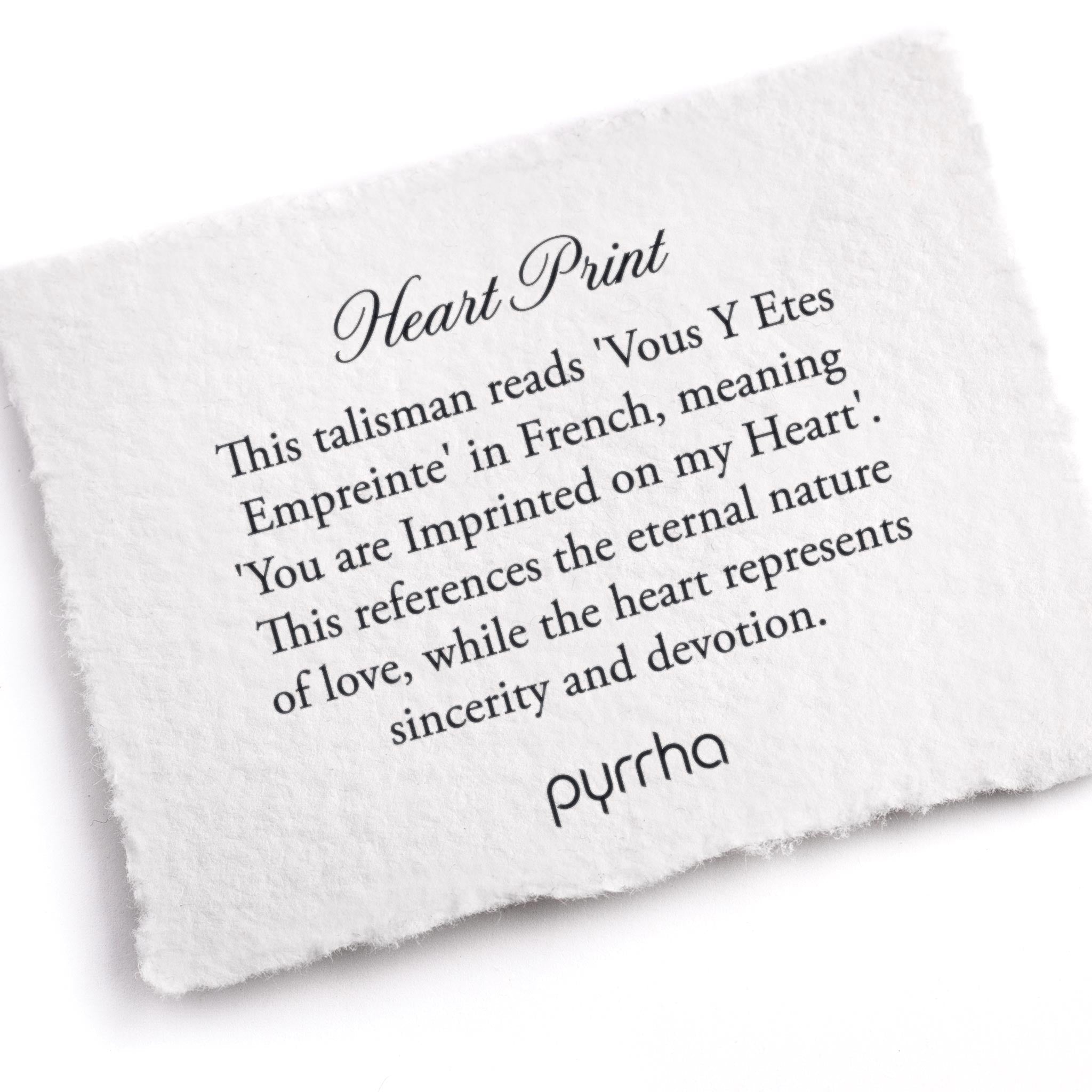 A hand-torn, letterpress printed card describing the meaning for Pyrrha's Heart Print Talisman
