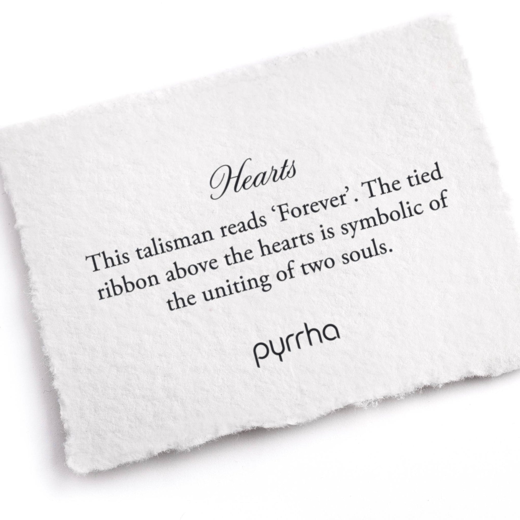 A hand-torn, letterpress printed card describing the meaning for Pyrrha's Hearts Talisman