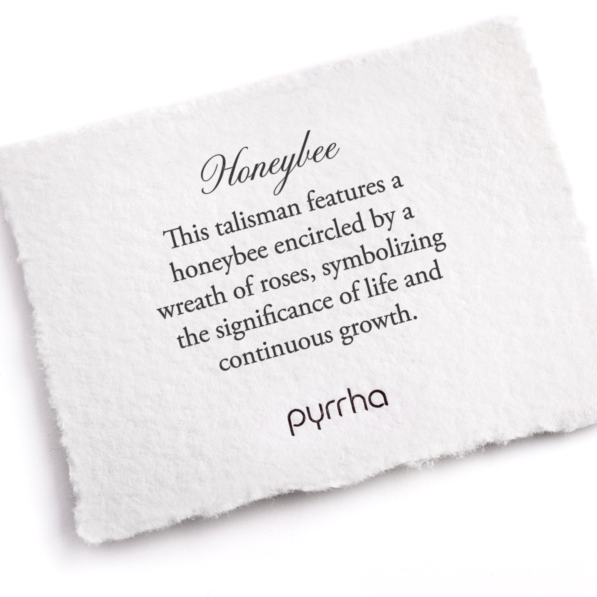 A hand-torn, letterpress printed card describing the meaning for Pyrrha's Honeybee Talisman