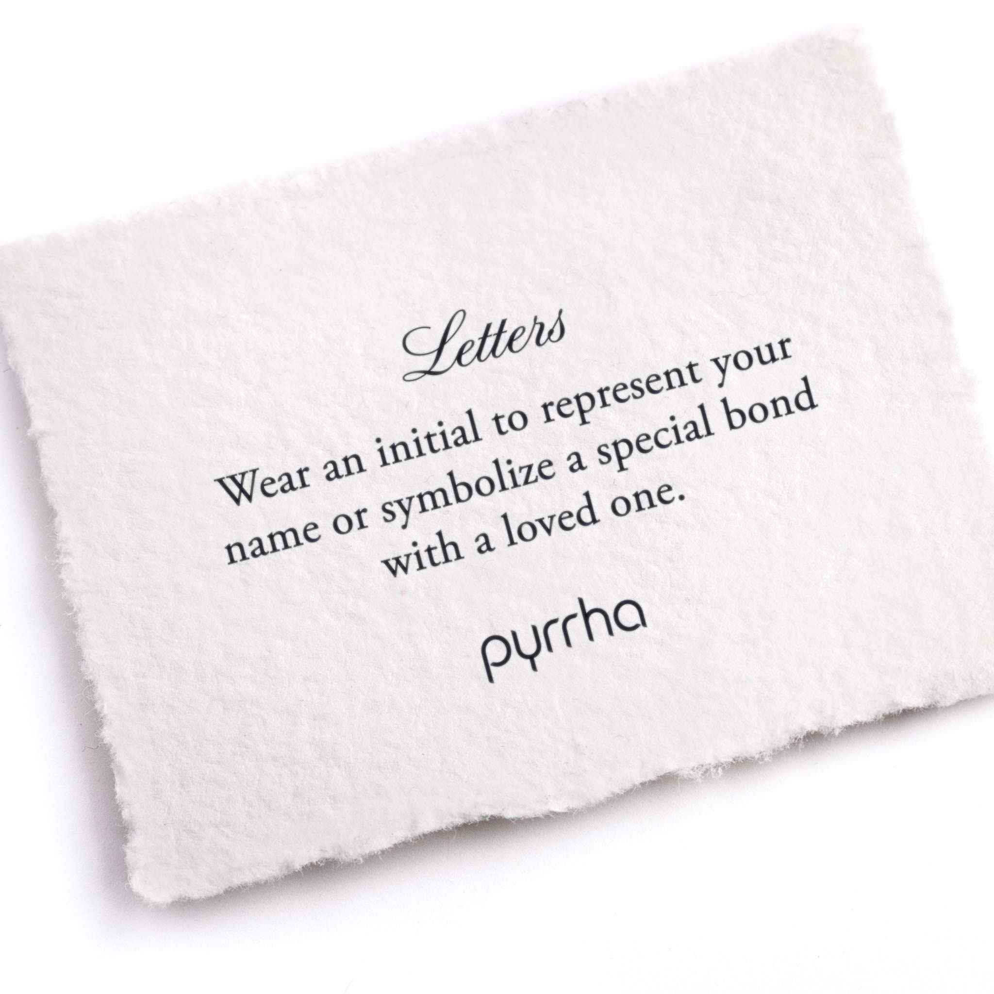 A hand-torn, letterpress printed card describing the meaning for Pyrrha's Letter charms