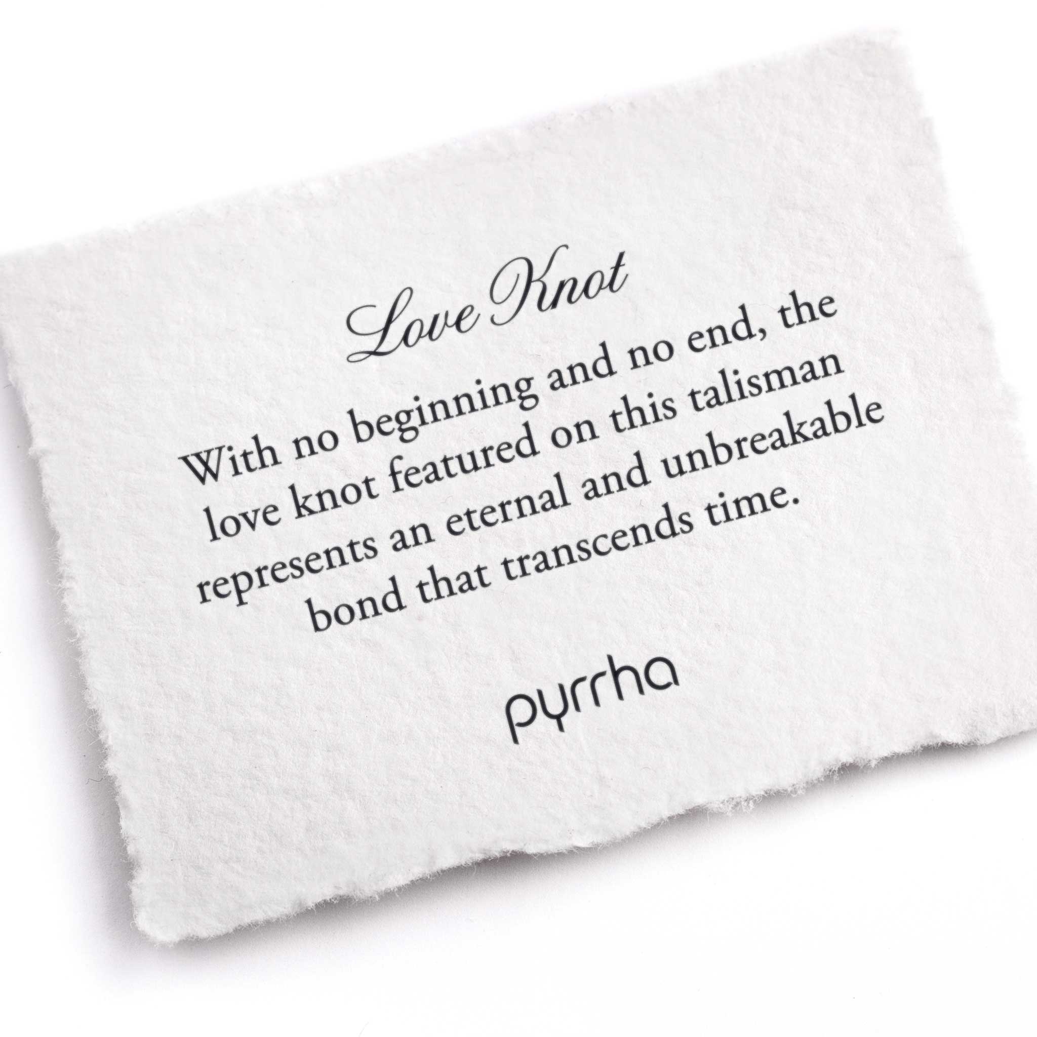 A hand-torn, letterpress printed card describing the meaning for Pyrrha's Love Knot Talisman