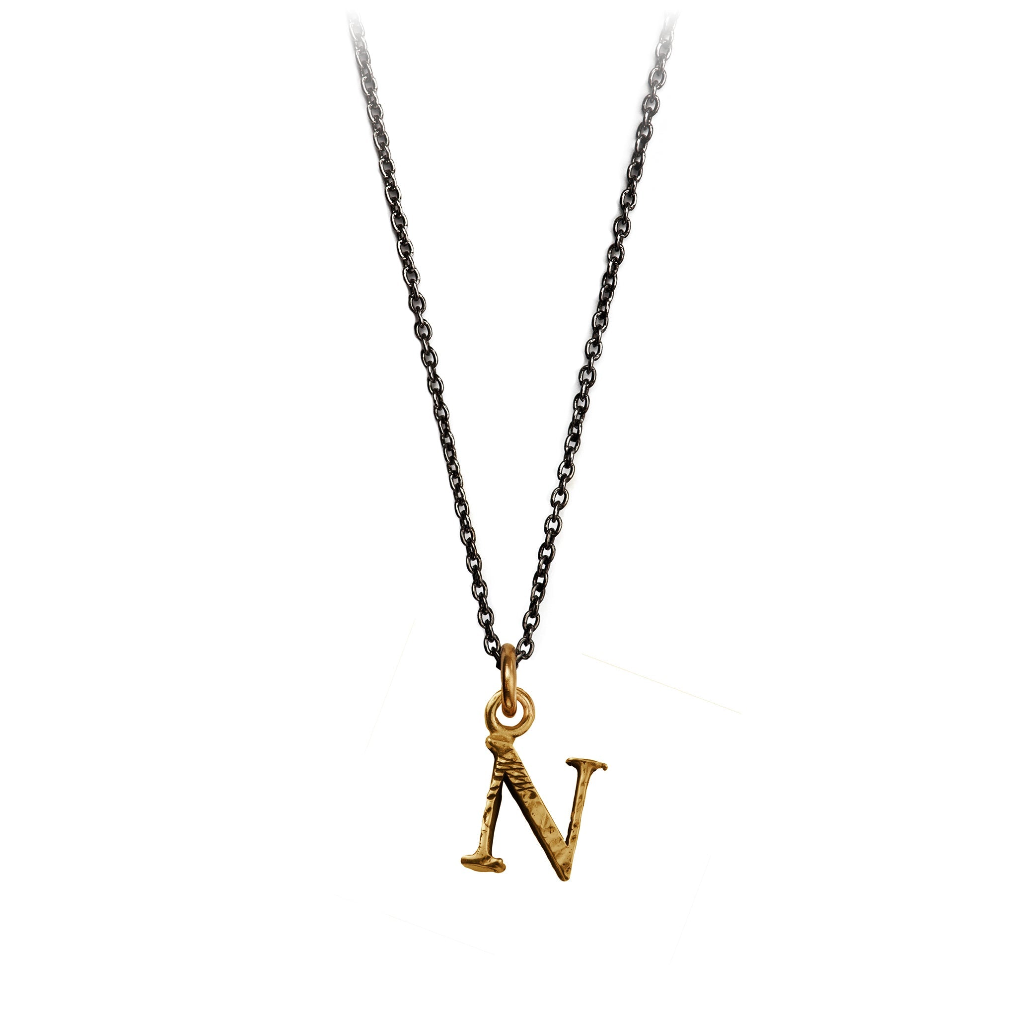 A bronze "N" charm on a blackened sterling silver chain.