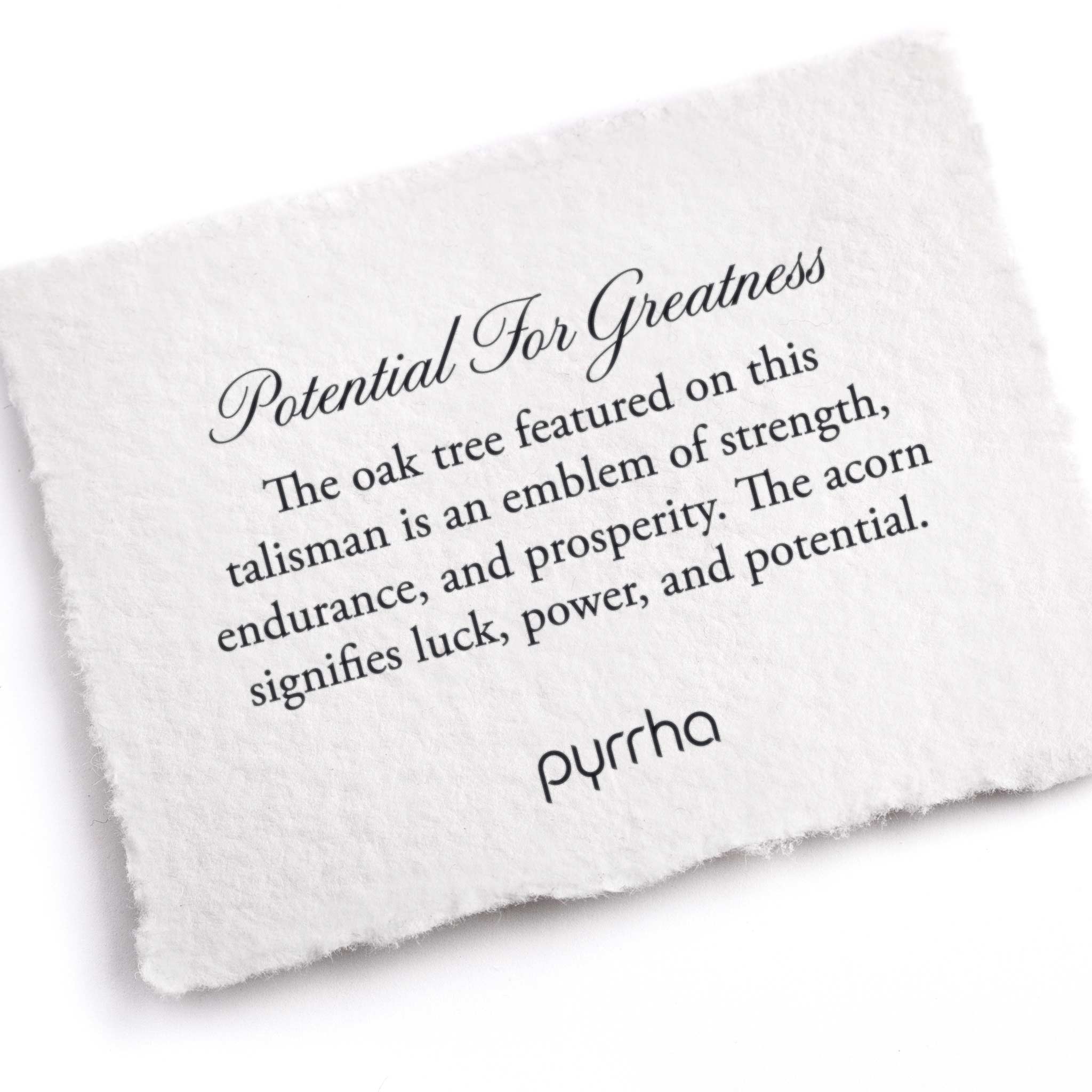 A hand-torn, letterpress printed card describing the meaning for Pyrrha's Potential for Greatness Talisman