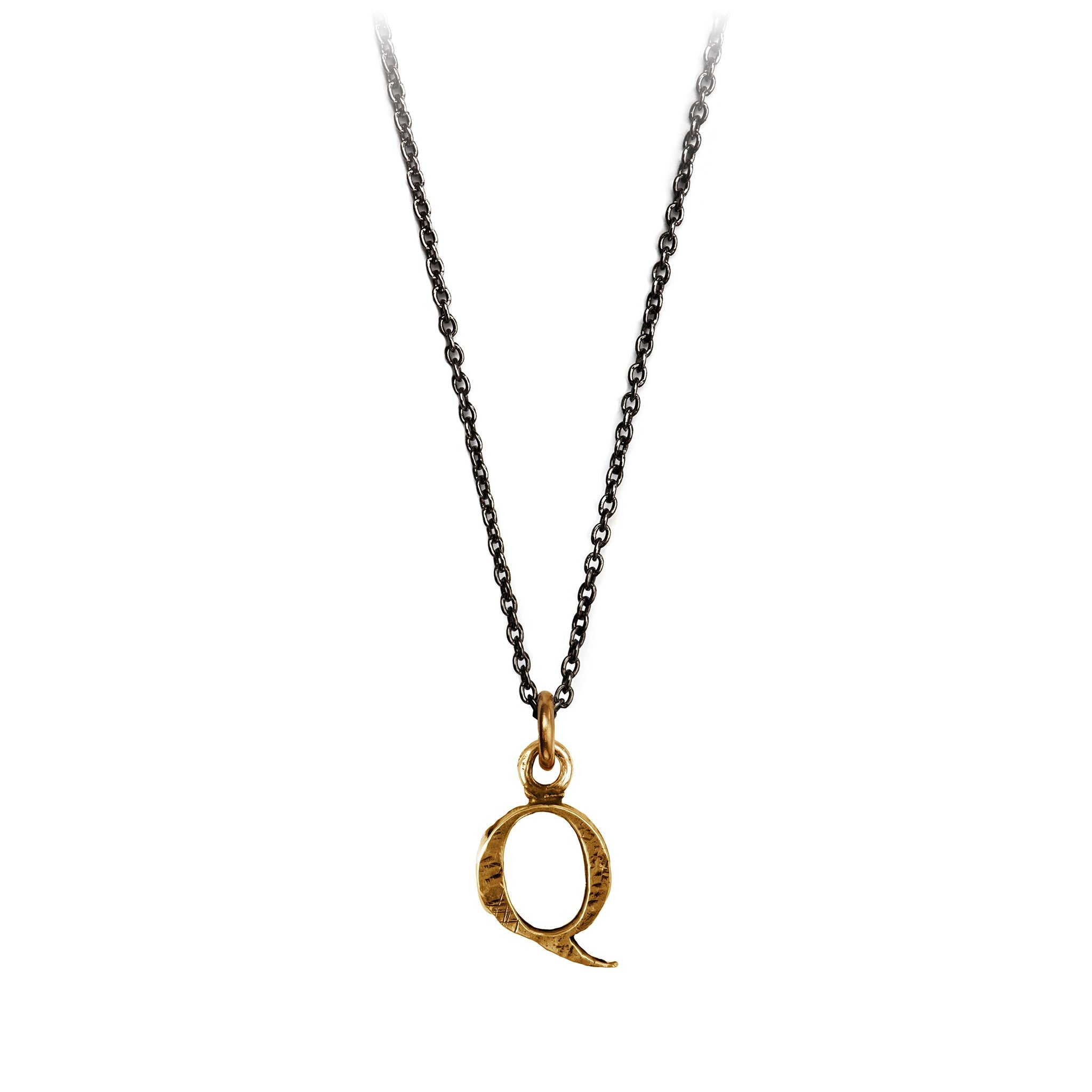 A bronze "Q" charm on a blackened sterling silver chain.