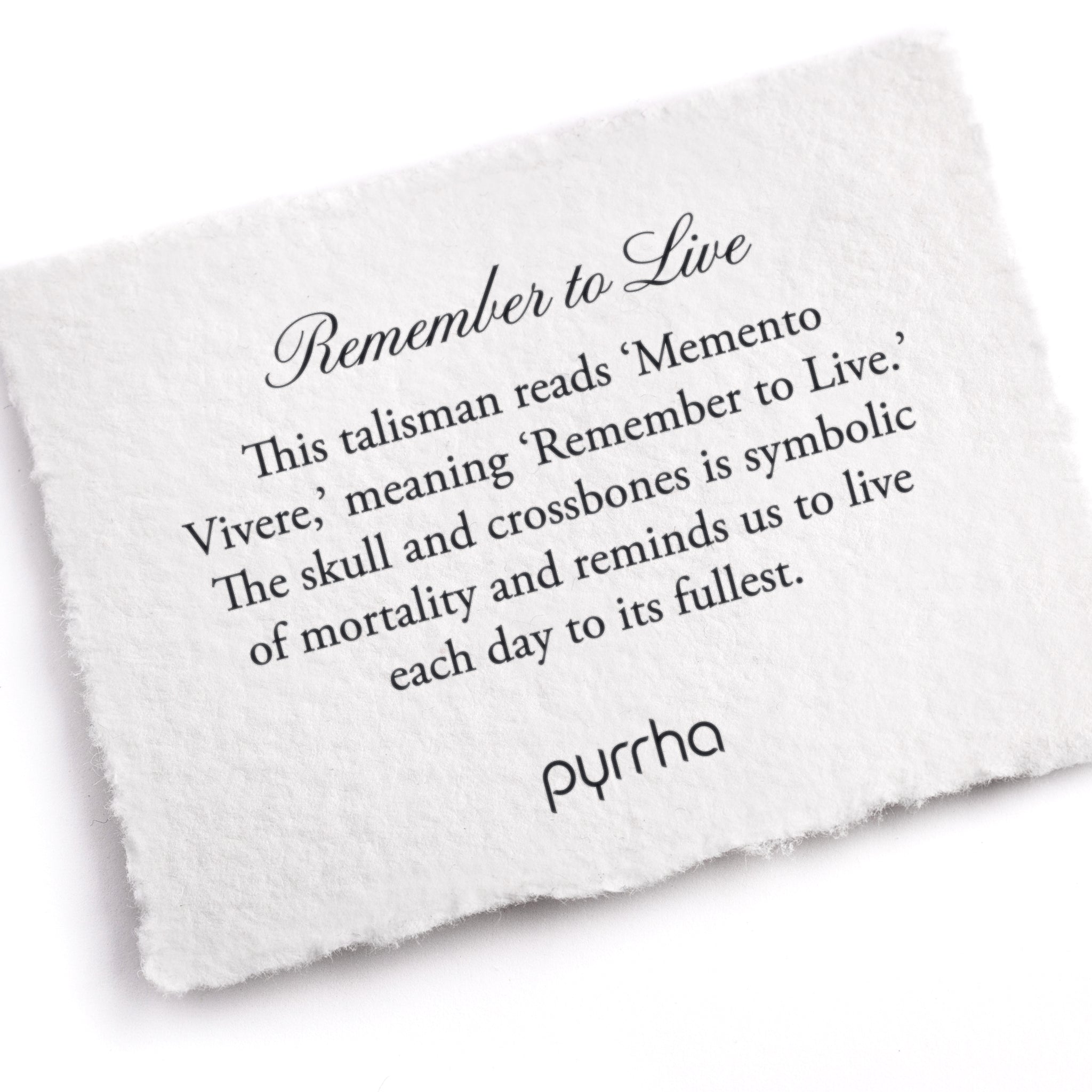 A hand-torn, letterpress printed card describing the meaning for Pyrrha's Remember to Live Talisman