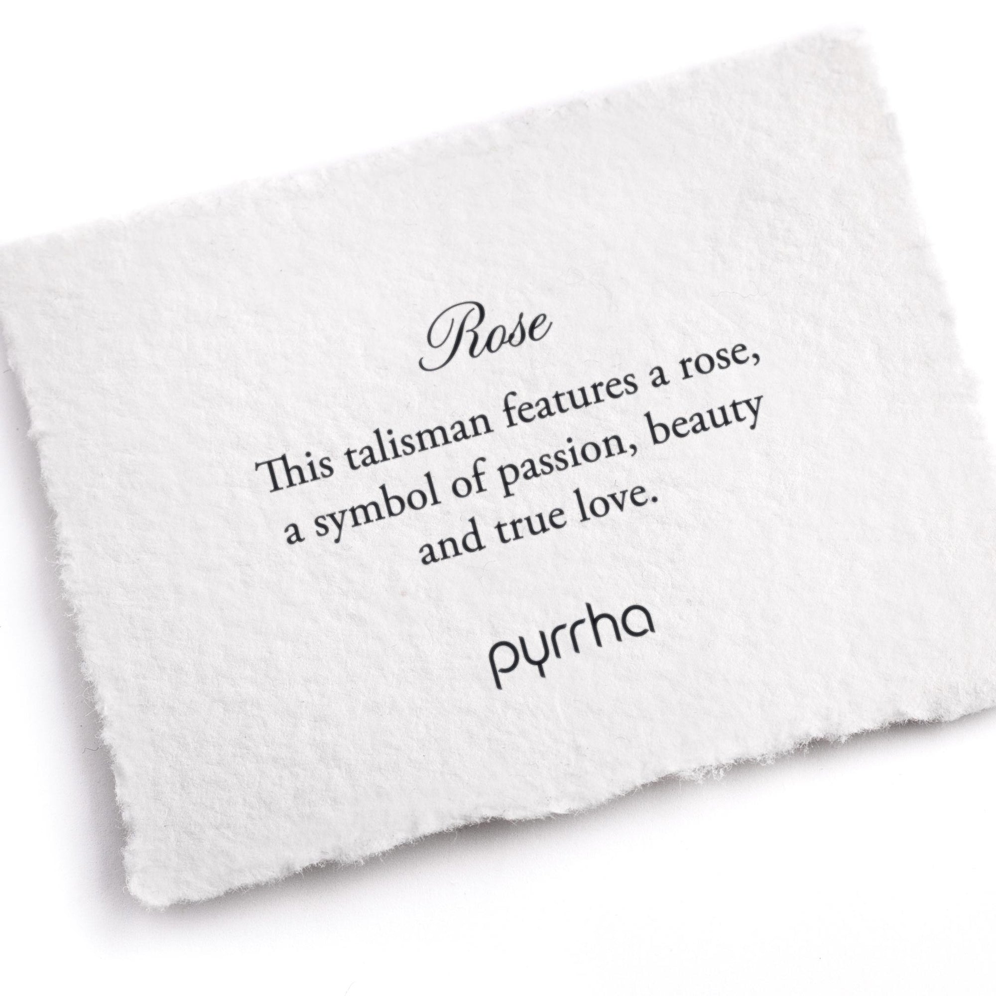 A hand-torn, letterpress printed card describing the meaning for Pyrrha's Rose Talisman