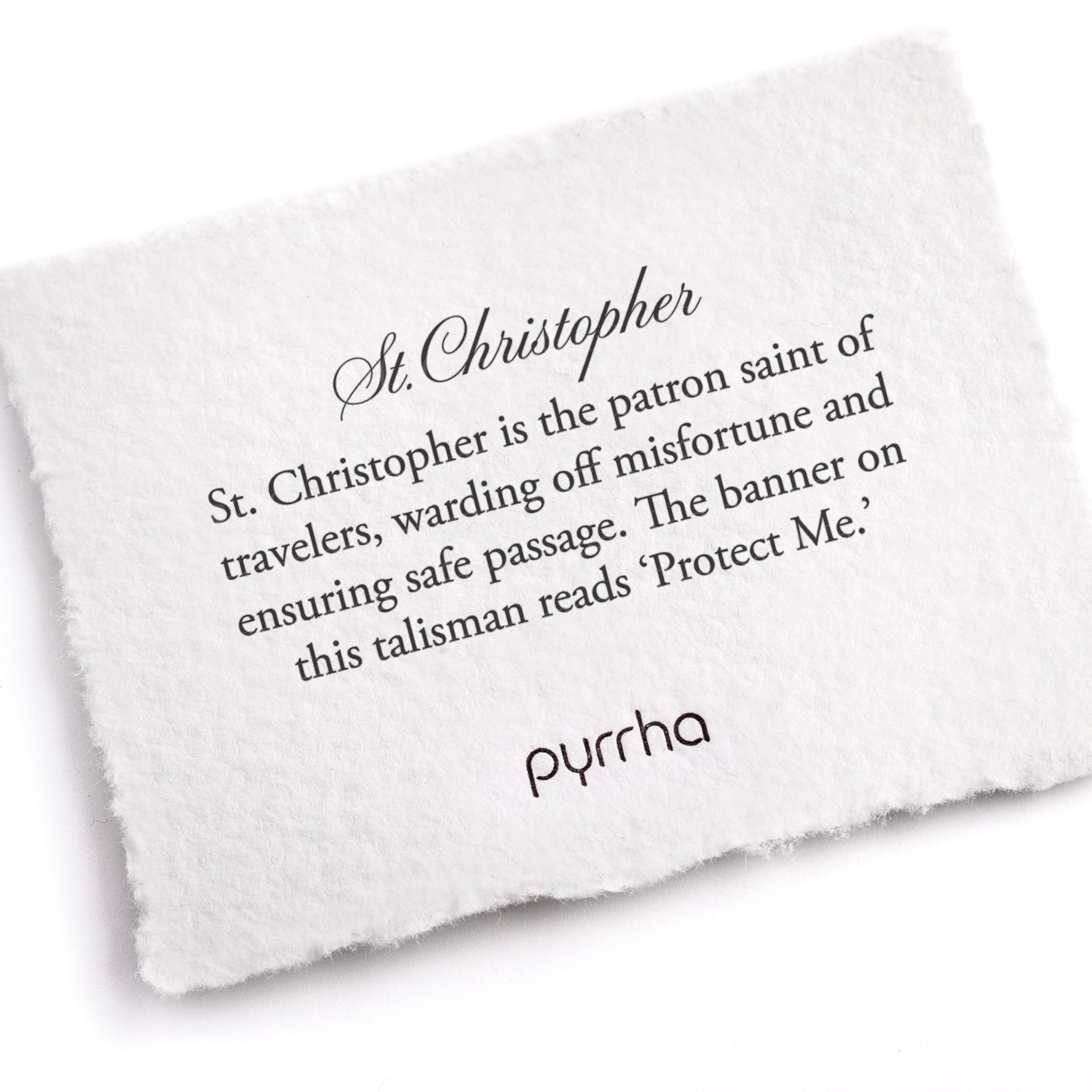 A hand-torn, letterpress printed card describing the meaning for Pyrrha's St. Christopher Talisman