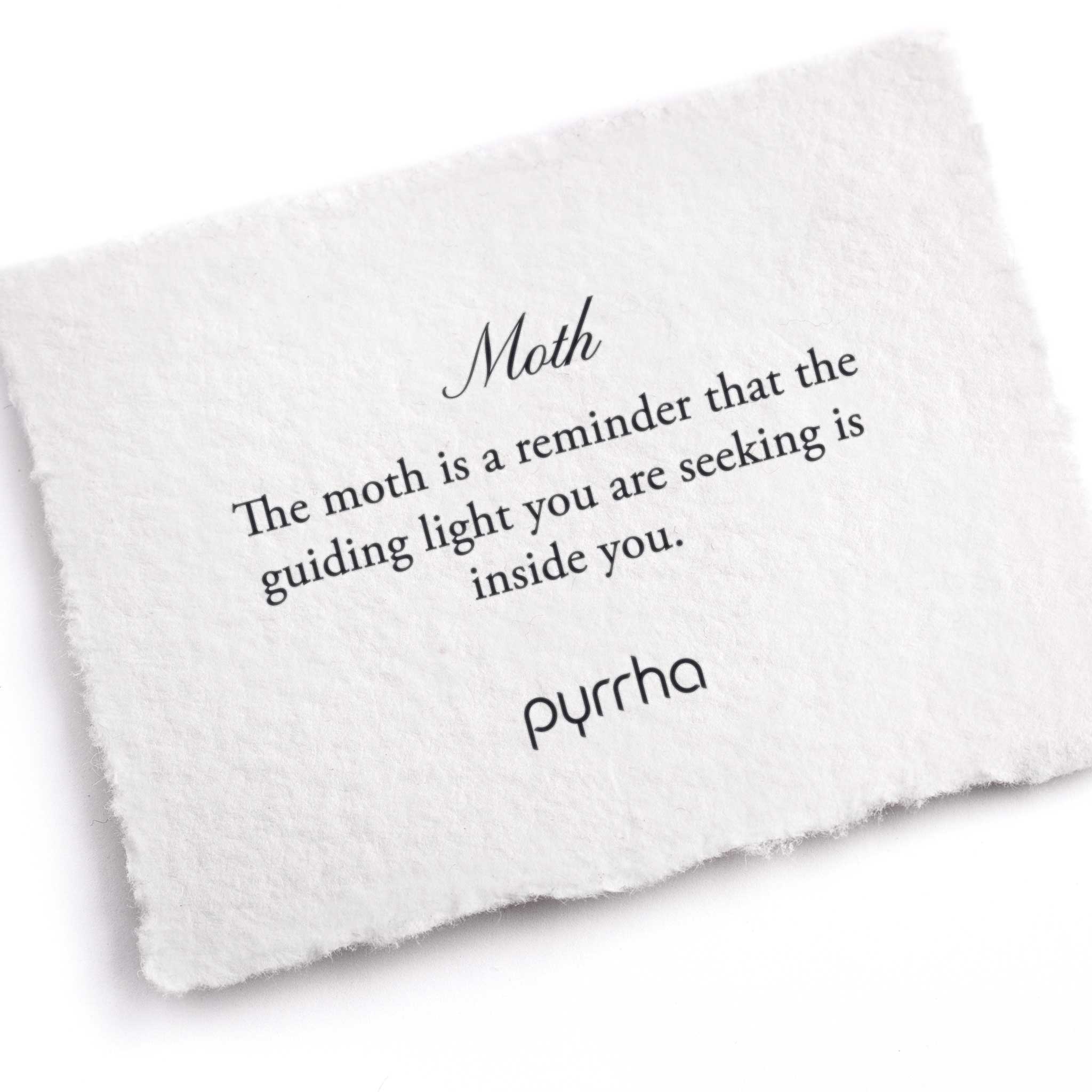 A hand-torn, letterpress printed card describing the meaning for Pyrrha's Moth stud