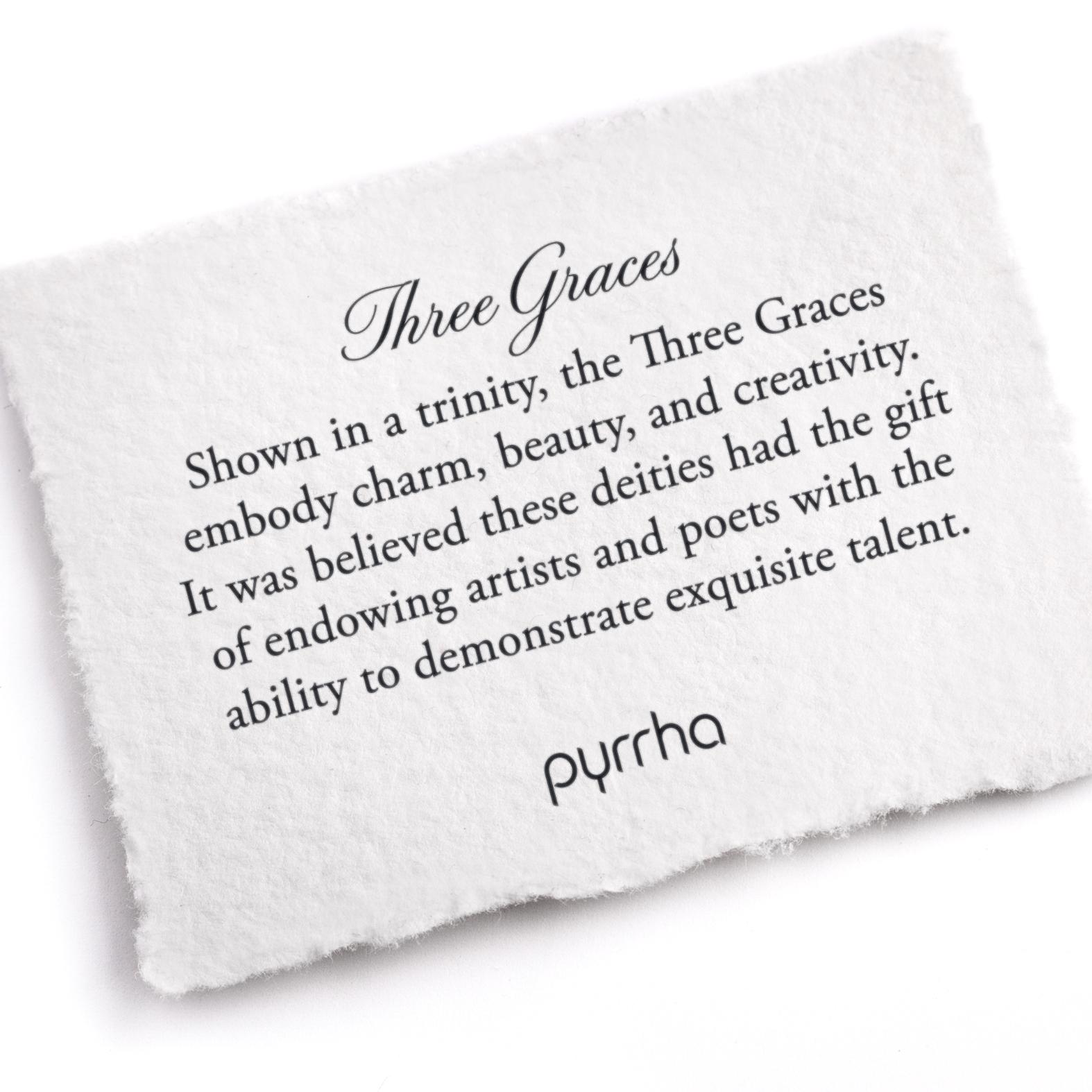 A hand-torn, letterpress printed card describing the meaning for Pyrrha's Three Graces Talisman
