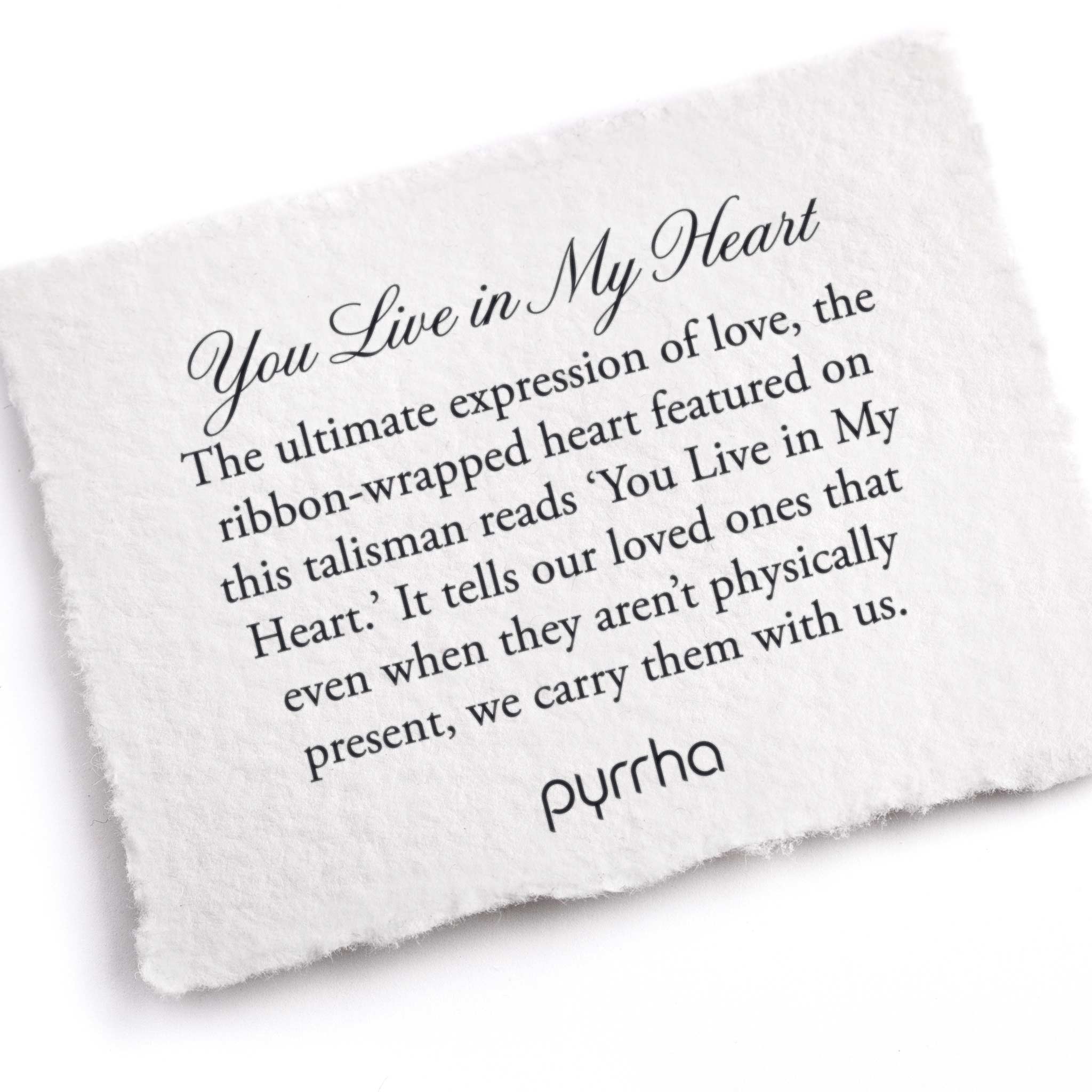 A hand-torn, letterpress printed card describing the meaning for Pyrrha's You Live in My Heart Knotted Pearl Necklace