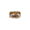 A wide 14k gold textured ring featuring the words From Here On printed on the band.