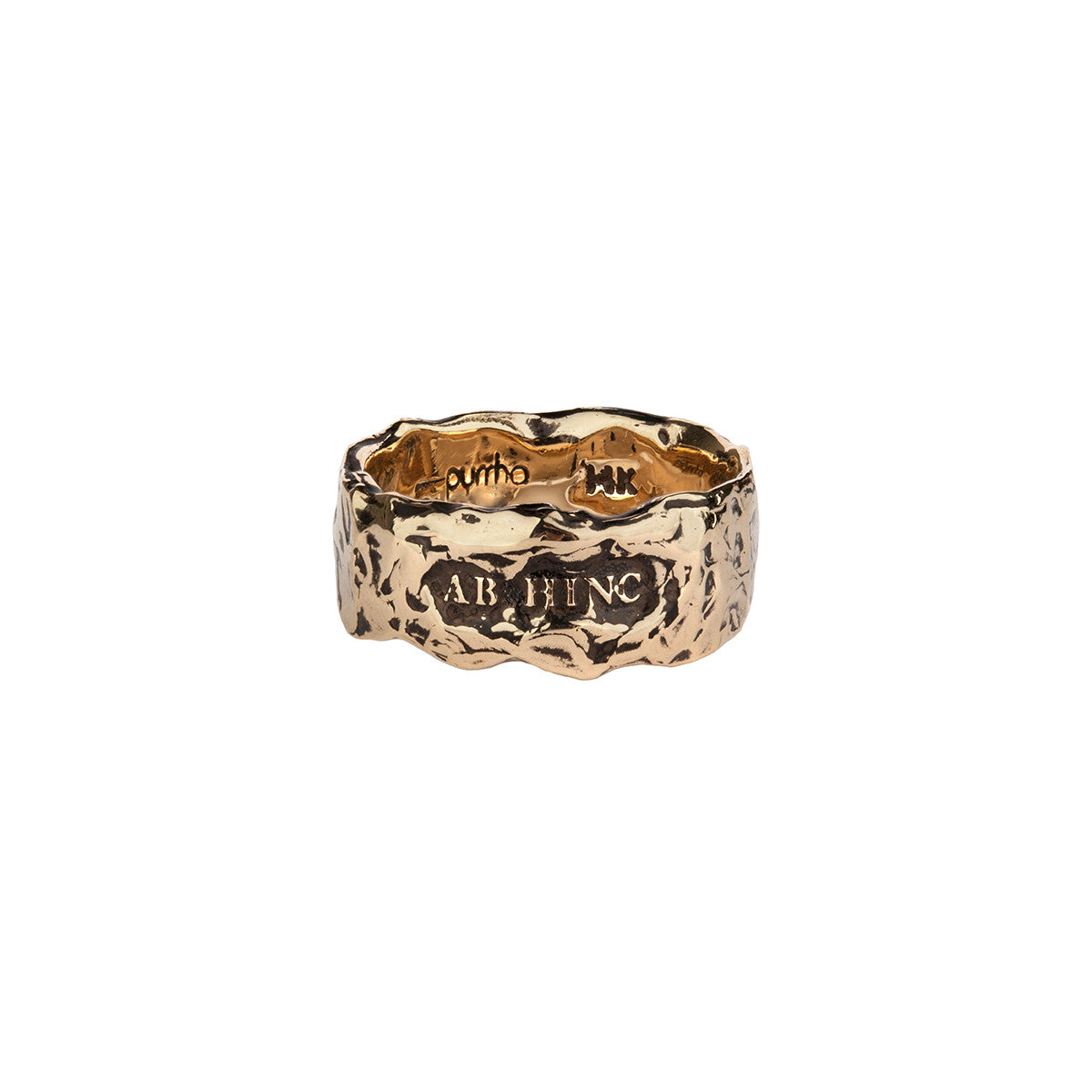 A wide 14k gold textured ring featuring the words From Here On printed on the band.