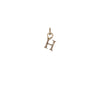 A 14k gold charm in the shape of the letter "H".