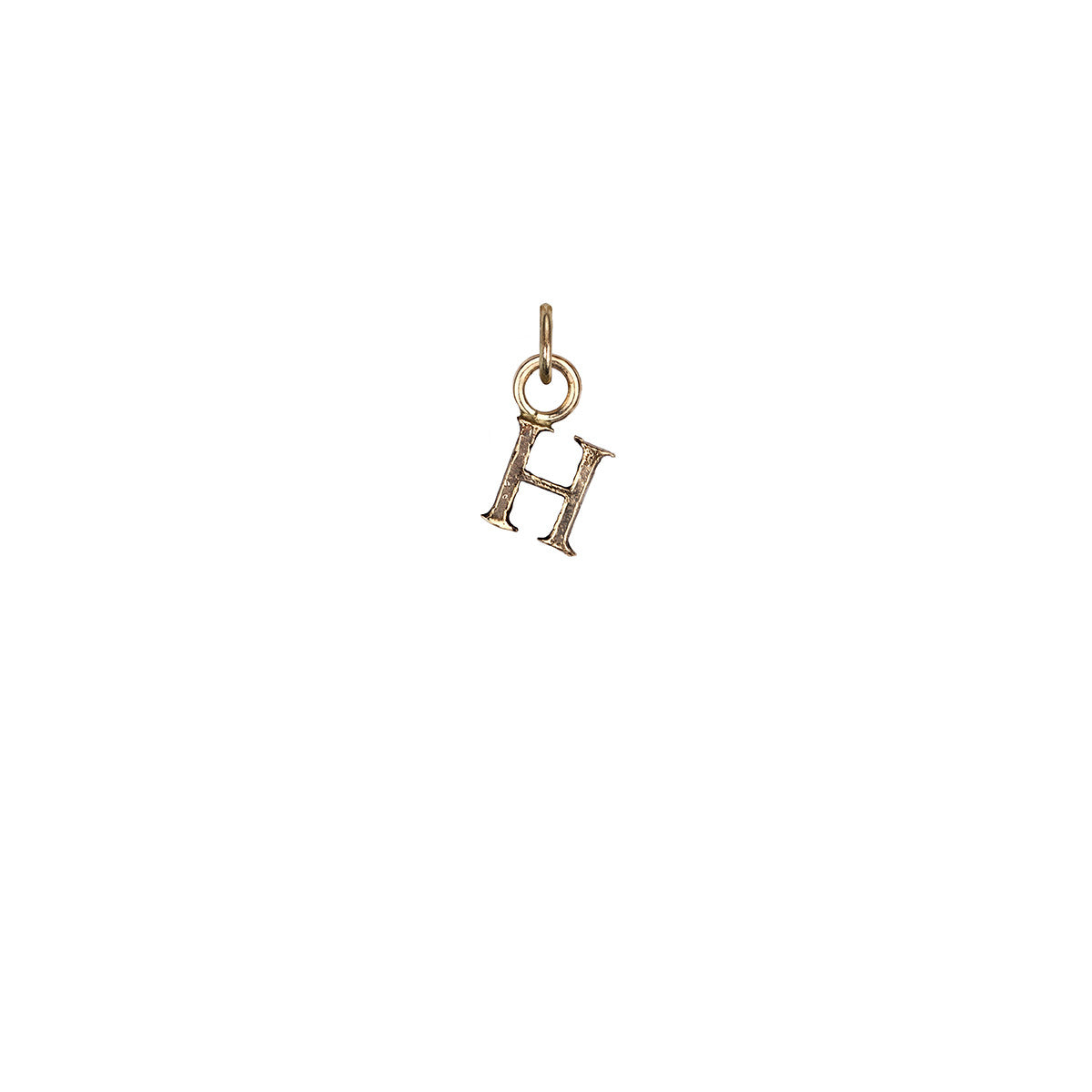 A 14k gold charm in the shape of the letter "H".