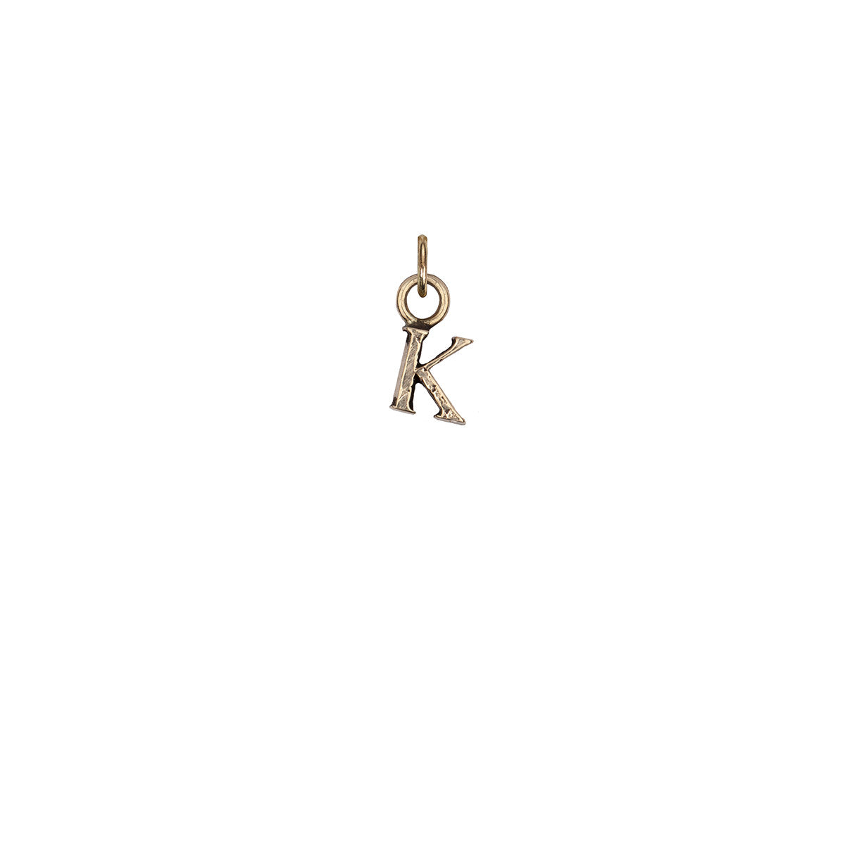A 14k gold charm in the shape of the letter "K".