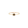 A 14k gold ring featuring a gold set black diamond.