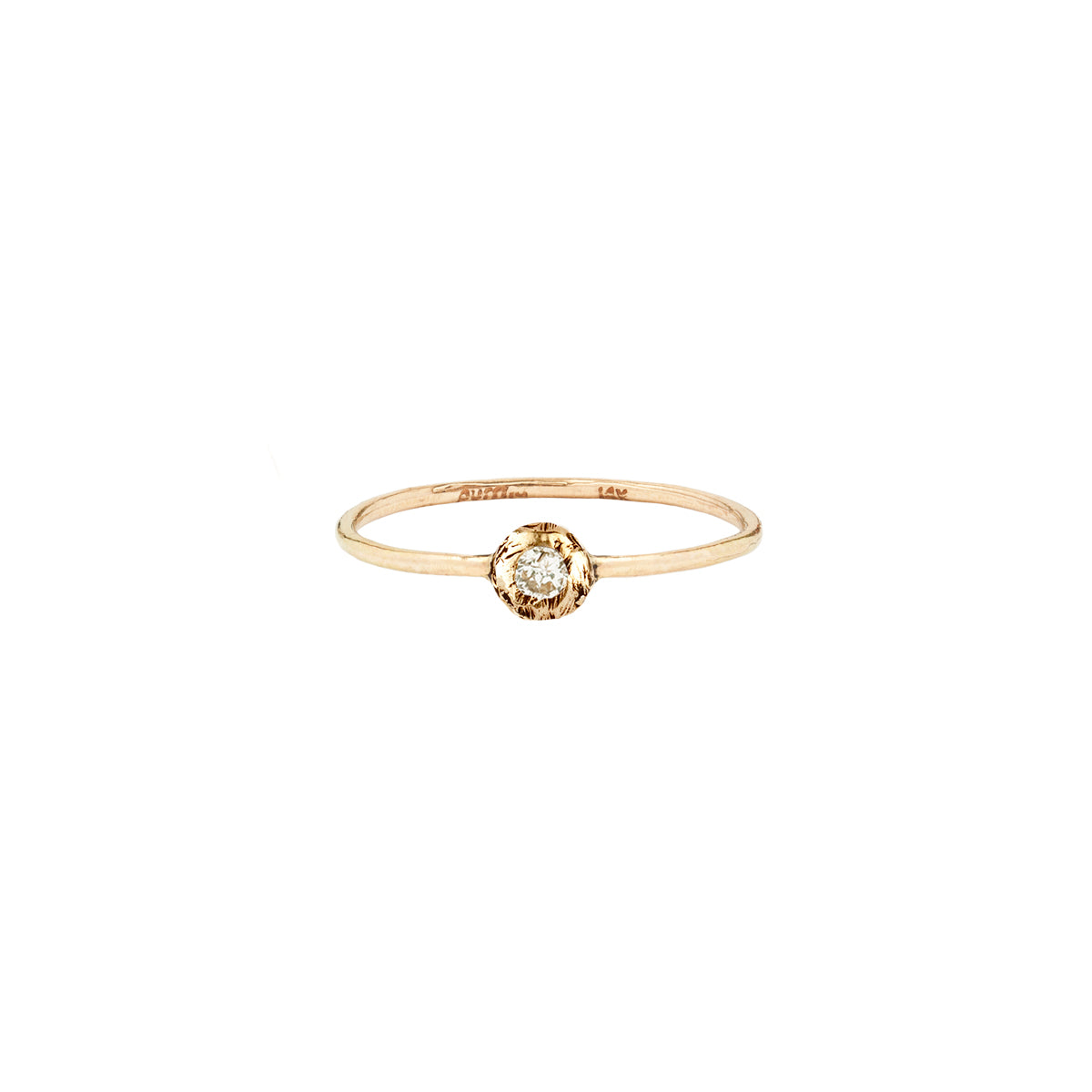 A 14k gold ring featuring a gold set white diamond.