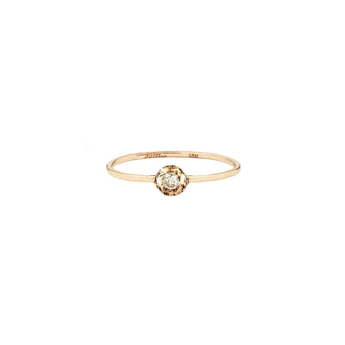 A 14k gold ring featuring a gold set white diamond.