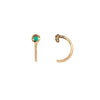 A set of 14k gold hug earrings set with an emerald.