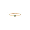 A 14k gold ring featuring a gold set emerald.