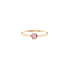 A 14k gold ring featuring a gold set pink sapphire.