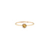 A 14k gold ring featuring a gold set yellow sapphire.