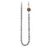 A necklace of hand strung dove grey pearls with a 14k gold bezel set cognac diamond.