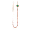 A necklace of hand strung rose pearls with a 14k gold bezel set emerald.