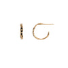 A set of extra small 14k gold hoop earrings with a textured design and three diamonds.
