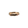 A narrow 14k gold ring set with a ruby featuring the words From Here On printed on the band.