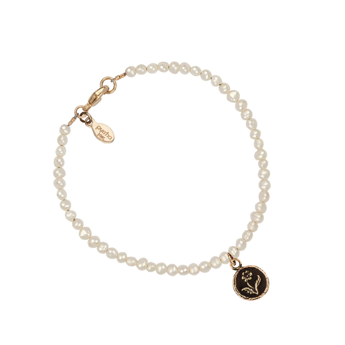 A hand-knotted bracelet of ivory pearls featuring our 14k gold rose talisman.