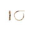 A set of small 14k gold hoop earrings set with a sapphire.