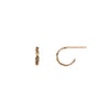 A set of tiny 14k gold hoop earrings with a textured design.