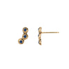 A set of 14k gold stud earrings set with three sapphires.